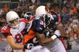DENVER - SEPTEMBER 3: Safety David Bruton #30 of the Denver Broncos gets tackled by wide receiver Jerheme Urban #85 of the Arizona Cardinals after Bruton intercepted a pass by Cardinals quarterback Matt Leinart (not pictured) in the second quarter of the NFL preseason game at Invesco Field at Mile High on September 3, 2009 in Denver, Colorado.  (Photo by Doug Pensinger/Getty Images)
