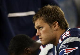 FOXBORO, MA - SEPTEMBER 03:  Tom Brady #12 of the New England Patriots looks on from the bench in the first half against the New York Giants on September 3, 2009 at Gillette Stadium in Foxboro, Massachusetts.  (Photo by Elsa/Getty Images)