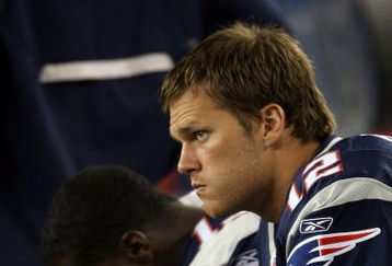 FOXBORO, MA - SEPTEMBER 03:  Tom Brady #12 of the New England Patriots looks on from the bench in the first half against the New York Giants on September 3, 2009 at Gillette Stadium in Foxboro, Massachusetts.  (Photo by Elsa/Getty Images)