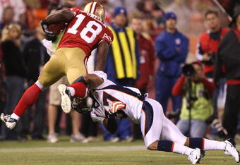SAN FRANCISCO - AUGUST 14:  Michael Spurlock #18 of the San Francisco 49ers is tackled by Tony Carter #37 of the Denver Broncos during a preseason game on August 14, 2009 at Candlestick Park in San Francisco, California.  (Photo by Jed Jacobsohn/Getty Images)