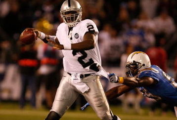 SAN DIEGO - DECEMBER 04:  Quarterback JaMarcus Russell #2 of the Oakland Raiders is grabbed by Linebacker Shaun Philips #95 of the San Diego Chargers during their NFL Game on December 4, 2008 at Qualcomm Stadium in San Diego, California.  (Photo by Harry How/Getty Images)