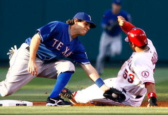 ANAHEIM, CA - JULY 07:  Bobby Abreu #53 of the Los Angeles Angels of Anaheim slides safely under the tag of second baseman Ian Kinsler #5 of the Texas Rangers for a stolen base in the first inning at Angel Stadium on July 7, 2009 in Anaheim, California. The Rangers defeated the Angels 8-5.  (Photo by Jeff Gross/Getty Images)