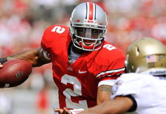 COLUMBUS, OH - SEPTEMBER 05:  Quarterback Terrelle Pryor #2 of the Ohio State Buckeyes tries to elude the tackle of Blake Carter #1 of the Navy Midshipmen at Ohio Stadium on September 5, 2009 in Columbus, Ohio.  Pryor ran for one touchdown and threw for one touchdown as Ohio State narrowly defeated Navy 31-27. (Photo by Jamie Sabau/Getty Images)