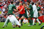 LONDON, ENGLAND - SEPTEMBER 05:  Referee Jonas Eriksson is surrounded as he awards a penalty against Bostjan Cesar of Slovenia for a foul on Wayne Rooney of England during the International Friendly match between England and Slovenia at Wembley Stadium on September 5, 2009 in London, England.  (Photo by Mark Thompson/Getty Images)