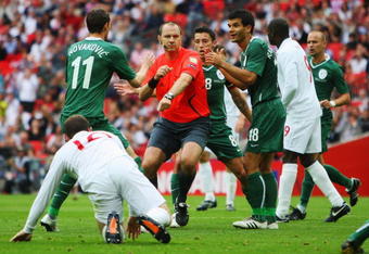 LONDON, ENGLAND - SEPTEMBER 05:  Referee Jonas Eriksson is surrounded as he awards a penalty against Bostjan Cesar of Slovenia for a foul on Wayne Rooney of England during the International Friendly match between England and Slovenia at Wembley Stadium on September 5, 2009 in London, England.  (Photo by Mark Thompson/Getty Images)