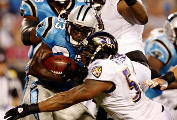 CHARLOTTE, NC - AUGUST 29: Linebacker Ray Lweis #52 of the Baltimore Ravens hits running back Mikie Goodson #33 of the Carolina Panthers during their preseason game at Bank of America Stadium on August 29, 2009 in Charlotte, North Carolina. (Photo by Streeter Lecka/Getty Images)