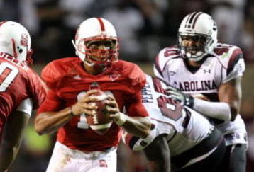 RALEIGH, NC - SEPTEMBER 3:  Quarterback Russell Wilson #16 of the North Carolina State Wolfpack drops back to pass with protection by Jeraill McCuller #50 against the South Carolina Gamecocks during the game at Carter-Finley Stadium on September 3, 2009 in Raleigh, North Carolina. (Photo by Streeter Lecka/Getty Images)