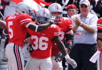 COLUMBUS, OH - SEPTEMBER 05:  Ohio State Buckeyes players congratulate Brian Rolle #36 of the Buckeyes after Rolle intercepted a Navy Midshipmen two-point conversion attempt and returned it 100 yards to the Navy endzone at Ohio Stadium on September 5, 2009 in Columbus, Ohio. Ohio State was granted the two points and held off Navy 31-27.  (Photo by Jamie Sabau/Getty Images)
