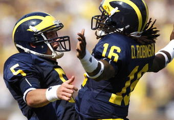 ANN ARBOR, MI - SEPTEMBER 05:  Tate Forcier #5 of the Michigan Wolverines celebrates with Denard Robinson #16 after Robinson ran for a long first quarter touchdown against the Western Michigan Broncos on September 5, 2009 at Michigan Stadium in Ann Arbor, Michigan.  (Photo by Gregory Shamus/Getty Images)