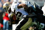CHARLOTTE, NC - OCTOBER 19:  Running back Reggie Bush #25 of the New Orleans Saints is tackled by Na'il Diggs #53 and Tyler Brayton #96 of the Carolina Panthers during the game at Bank of America Stadium on October 19, 2008 in Charlotte, North Carolina.  (Photo by Kevin C. Cox/Getty Images)