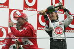 MONZA, ITALY - SEPTEMBER 12:  Jenson Button of Great Britain and B.A.R soaks Rubens Barichello of Brazil with champagne after he won the Italian F1 Grand Prix at the Autodromo Nazionale di Monza Circuit on September 12, 2004, in Monza, Italy. (Photo by Mark Thompson/Getty Images) 