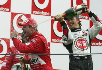 MONZA, ITALY - SEPTEMBER 12:  Jenson Button of Great Britain and B.A.R soaks Rubens Barichello of Brazil with champagne after he won the Italian F1 Grand Prix at the Autodromo Nazionale di Monza Circuit on September 12, 2004, in Monza, Italy. (Photo by Mark Thompson/Getty Images) 