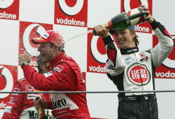 MONZA, ITALY - SEPTEMBER 12:  Jenson Button of Great Britain and B.A.R soaks Rubens Barichello of Brazil with champagne after he won the Italian F1 Grand Prix at the Autodromo Nazionale di Monza Circuit on September 12, 2004, in Monza, Italy. (Photo by Mark Thompson/Getty Images) 
