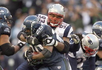 SEATTLE - DECEMBER 07:  Richard Seymour #93 of the New England Patriots tackles Maurice Morris #20 of the Seattle Seahawks during the game on December 7, 2008 at Qwest Field in Seattle, Washington. The Patriots defeated the Seahawks 24-21. (Photo by Otto Greule Jr/Getty Images)