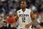 DETROIT - APRIL 04:  A.J. Price #12 of the Connecticut Huskies moves the ball while taking on the Michigan State Spartans during the National Semifinal game of the NCAA Division I Men's Basketball Championship at Ford Field on April 4, 2009 in Detroit, Michigan.  (Photo by Gregory Shamus/Getty Images)