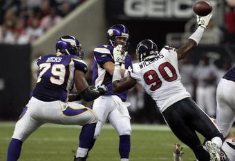HOUSTON - AUGUST 31:  Quarterback Brett Favre #4 of the Minnestoa Vikings releases the ball as he is pressured by defensive end Mario Williams #90 of the Houston Texans at Reliant Stadium on August 31, 2009 in Houston, Texas.  (Photo by Bob Levey/Getty Images)