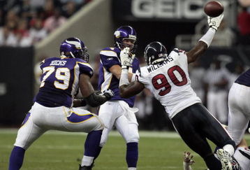 HOUSTON - AUGUST 31:  Quarterback Brett Favre #4 of the Minnestoa Vikings releases the ball as he is pressured by defensive end Mario Williams #90 of the Houston Texans at Reliant Stadium on August 31, 2009 in Houston, Texas.  (Photo by Bob Levey/Getty Images)