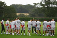 LONDON COLNEY, ENGLAND - AUGUST 25: Arsenal manager Arsene Wenger talks to his players during an Arsenal Training Session at London Colney on August 25, 2009 in London Colney, England. (Photo by Paul Gilham/Getty Images)
