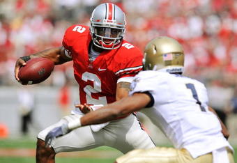 COLUMBUS, OH - SEPTEMBER 05:  Quarterback Terrelle Pryor #2 of the Ohio State Buckeyes tries to elude the tackle of Blake Carter #1 of the Navy Midshipmen at Ohio Stadium on September 5, 2009 in Columbus, Ohio.  Pryor ran for one touchdown and threw for one touchdown as Ohio State narrowly defeated Navy 31-27. (Photo by Jamie Sabau/Getty Images)