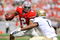 COLUMBUS, OH - SEPTEMBER 05:  Quarterback Terrelle Pryor #2 of the Ohio State Buckeyes tries to elude the tackle of Blake Carter #1 of the Navy Midshipmen at Ohio Stadium on September 5, 2009 in Columbus, Ohio.  Pryor ran for one touchdown and threw for one touchdown as Ohio State narrowly defeated Navy 31-27. (Photo by Jamie Sabau/Getty Images)