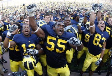 ANN ARBOR, MI - SEPTEMBER 05:  Brandon Graham #55 of the Michigan Wolverines leads his teammates in singing the schools fight song after beating the Western Michigan Broncos 31-7 on September 5, 2009 at Michigan Stadium in Ann Arbor, Michigan.  (Photo by Gregory Shamus/Getty Images)