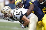 ANN ARBOR, MI - SEPTEMBER 05:  Obi Ezeh #45 of the Michigan Wolverines sacks Tim Hiller #3 of the Western Michigan Broncos on September 5, 2009 at Michigan Stadium in Ann Arbor, Michigan. Michigan won the game 31-7. (Photo by Gregory Shamus/Getty Images)