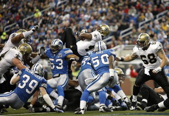 DETROIT - DECEMBER 21: Running back Mike Bell #40 of the New Orleans Saints scores a one yard touchdown in the second quarter against the Detroit Lions on December 21, 2008 at Ford Field in Detroit, Michigan.  (Photo by Leon Halip/Getty Images)