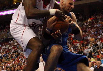 PHILADELPHIA - APRIL 26:  Reggie Evans #33 of the Philadelphia 76ers battles for the ball against Marcin Gortat #13 of the Orlando Magic during Game Four of the Eastern Conference Quarterfinals during the 2009 NBA Playoffs at the Wachovia Center on April 26, 2009 in Philadelphia, Pennsylvania. NOTE TO USER: User expressly acknowledges and agrees that, by downloading and/or using this Photograph, user is consenting to the terms and conditions of the Getty Images License Agreement.  (Photo by Jim McIsaac/Getty Images)