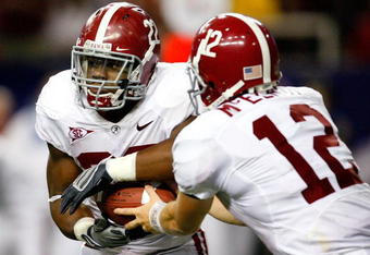 ATLANTA - SEPTEMBER 05:  Running back Mark Ingram #22 of the Alabama Crimson Tide takes a handoff from quarterback Greg McElroy #12 against the Virginia Tech Hokies during the Chick-fil-A Kickoff Game at Georgia Dome on September 5, 2009 in Atlanta, Georgia.  (Photo by Kevin C. Cox/Getty Images)