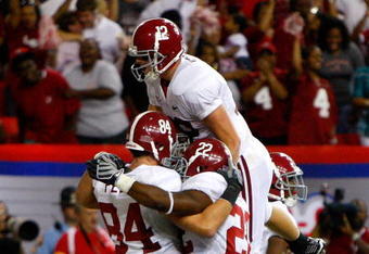 ATLANTA - SEPTEMBER 05:  Quarterback Greg McElroy #12 of the Alabama Crimson Tide celebrates with Mark Ingram #22 and Colin Peek #84 after Peek's two-point conversion against the Virginia Tech Hokies during the Chick-fil-A Kickoff Game at Georgia Dome on September 5, 2009 in Atlanta, Georgia.  (Photo by Kevin C. Cox/Getty Images)