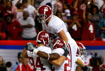 ATLANTA - SEPTEMBER 05:  Quarterback Greg McElroy #12 of the Alabama Crimson Tide celebrates with Mark Ingram #22 and Colin Peek #84 after Peek's two-point conversion against the Virginia Tech Hokies during the Chick-fil-A Kickoff Game at Georgia Dome on September 5, 2009 in Atlanta, Georgia.  (Photo by Kevin C. Cox/Getty Images)