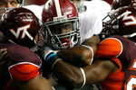 ATLANTA - SEPTEMBER 05:  Running back Mark Ingram #22 of the Alabama Crimson Tide rushes against Barquell Rivers #52 and Dorian Porch #24 of the Virginia Tech Hokies during the Chick-fil-A Kickoff Game at Georgia Dome on September 5, 2009 in Atlanta, Georgia.  (Photo by Kevin C. Cox/Getty Images)
