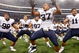 ARLINGTON, TX - SEPTEMBER 05:  (L-R) Romney Fuga #98, Vic So'oto #37 and Manase Tonga #11 of the Brigham Young Cougars celebrate a 14-13 win against the Oklahoma Sooners at Cowboys Stadium on September 5, 2009 in Arlington, Texas.  (Photo by Ronald Martinez/Getty Images)