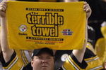 Pittsburgh Steelers fan hoists the terrible towel during play  against the Miami Dolphins during the NFL's 2006 opening game on September 7, 2006 at Heinz Field in Pittsburgh, Pennsylvania.  The Steelers won 28 - 17.  (Photo by Al Messerschmidt/Getty Images)
