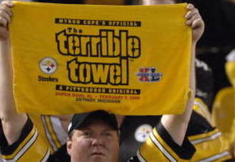 Pittsburgh Steelers fan hoists the terrible towel during play  against the Miami Dolphins during the NFL's 2006 opening game on September 7, 2006 at Heinz Field in Pittsburgh, Pennsylvania.  The Steelers won 28 - 17.  (Photo by Al Messerschmidt/Getty Images)