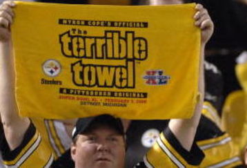Pittsburgh Steelers fan hoists the terrible towel during play  against the Miami Dolphins during the NFL's 2006 opening game on September 7, 2006 at Heinz Field in Pittsburgh, Pennsylvania.  The Steelers won 28 - 17.  (Photo by Al Messerschmidt/Getty Images)