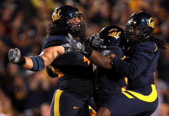 BERKELEY, CA - SEPTEMBER 05:  Tyson Alualu #44, Cameron Jordan #97, and Syd'quan Thompson #5 of the California Golden Bears celebrate after they caused a fumble during the first half of their game against the Maryland Terrapins at California Memorial Stadium on September 5, 2009 in Berkeley, California.  (Photo by Ezra Shaw/Getty Images)