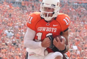 STILLWATER, OK - SEPTEMBER 5:  Quarterback Zac Robinson #11 of the Oklahoma State Cowboys celebrates his touchdown on a rush up the middle for 1 yard gain during the third quarter of the game against the Georgia Bulldogs at Boone Pickens Stadium on September 5, 2009 in Stillwater, Oklahoma. (Photo by Christian Petersen/Getty Images)