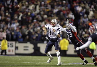 BUFFALO, NY - NOVEMBER 18: Tom Brady #12 of the New England Patriots passes underpresure by Anthony Hargrove #93 of the Buffalo Bills at Ralph Wilson Stadium November 18, 2007 in Orchard Park, New York. (Photo by Rick Stewart/Getty Images)