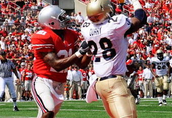 COLUMBUS, OH - SEPTEMBER 05:  Marcus Curry #28 of the Navy Midshipmen catches a touchdown pass in front of Anderson Russell #21 of the Ohio State Buckeyes at Ohio Stadium on September 5, 2009 in Columbus, Ohio. Curry had two touchdown catches in Navy's 31-27 loss to Ohio State.  (Photo by Jamie Sabau/Getty Images)