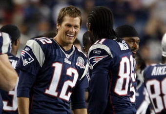 FOXBORO, MA - SEPTEMBER 03:  Tom Brady #12 of the New England Patriots and Randy Moss #81 celebrate in the fourth quarter against the New York Giants on September 3, 2009 at Gillette Stadium in Foxboro, Massachusetts. The Patriots defeated the Giants 38-27.  (Photo by Elsa/Getty Images)
