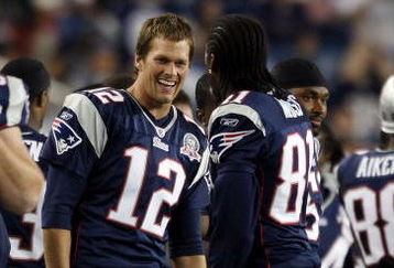 FOXBORO, MA - SEPTEMBER 03:  Tom Brady #12 of the New England Patriots and Randy Moss #81 celebrate in the fourth quarter against the New York Giants on September 3, 2009 at Gillette Stadium in Foxboro, Massachusetts. The Patriots defeated the Giants 38-27.  (Photo by Elsa/Getty Images)