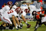 ATLANTA - SEPTEMBER 05:  Quarterback Greg McElroy #12 of the Alabama Crimson Tide takes the snap from William Vlachos #73 against the Virginia Tech Hokies during the Chick-fil-A Kickoff Game at Georgia Dome on September 5, 2009 in Atlanta, Georgia.  (Photo by Kevin C. Cox/Getty Images)