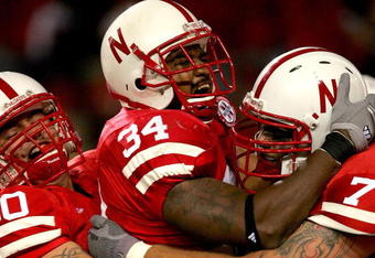 LINCOLN, NE - SEPTEMBER 15:  Cody Glenn #34 of the Nebraska Cornhuskers is congratulated by David Harvey #80 and Matt Slauson #70 after scoring a touchdown against the USC Trojans on September 15, 2007 at Memorial Stadium in Lincoln, Nebraska.  (Photo by Matthew Stockman/Getty Images)