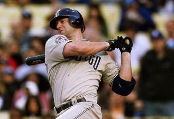 LOS ANGELES - JUNE 10:  Kevin Kouzmanoff #5 of the San Diego Padres hits an infield single for an RBI in the first inning against the Los Angeles Dodgers on June 10, 2009 at Dodger Stadium in Los Angeles, California.  (Photo by Stephen Dunn/Getty Images)