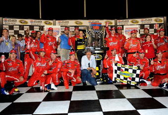 HAMPTON, GA - SEPTEMBER 06:  Kasey Kahne driver of the #9 Budweiser Dodge, celebrates in Victory Lane with his team after winning the NASCAR Sprint Cup Series Pep Boys Auto 500 at Atlanta Motor Speedway on September 6, 2009 in Hampton, Georgia.  (Photo by John Harrelson/Getty Images)