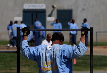 IONE, CA - AUGUST 28:  An inmate at the Mule Creek State Prison exercises through pull-ups in an outside yard August 28, 2007 in Ione, California. A panel of three federal judges is looking to put a cap on the California State Prison population after class action lawsuits were filed on behalf of inmates who complained of being forced to live in classrooms, gymnasiums and other non-traditional prison housing. California prisons house nearly 173,000 inmates with over 17,000 of them in non-traditional housing. The Mule Creek State Prison has had to modify several facilities to make room for an increasing number of inmates. (Photo by Justin Sullivan/Getty Images)