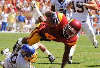 LOS ANGELES, CA - SEPTEMBER 05:  Joe McKnight #4 of the USC Trojans dives into the end zone to score a touchdown against Tiuke Tuipulotu #40 of the San Jose State Spartans during the second quarter at Los Angeles Memorial Coliseum on September 5, 2009 in Los Angeles, California.  (Photo by Kevork Djansezian/Getty Images)