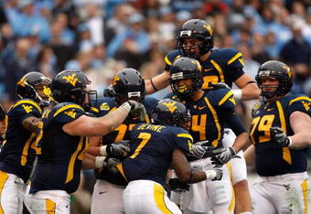 CHARLOTTE, NC - DECEMBER 27:  Noel Devine #7 of the West Virginia Mountaineers celebrates with his teammates after scoring a touchdown against the North Carolina Tar Heels during the Meineke Car Care Bowl on December 27, 2008 at Bank of America Stadium in Charlotte, North Carolina.  (Photo by Streeter Lecka/Getty Images)