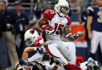 ST. LOUIS - NOVEMBER 02:  Steve Breaston #15 of the Arizona Cardinals is pulled down by Chris Chamberlain #57 of the St. Louis Rams on November 2, 2008 at the Edwards Jones Dome in St. Louis, Missouri. The Arizona Cardinals defeated the St. Louis Rams 34-13. (Photo by Elsa/Getty Images)